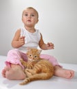 Toddler child plays with a cat