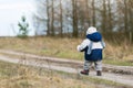 Toddler child walking by rural sandy road Royalty Free Stock Photo