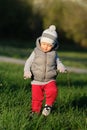 Toddler child in warm vest jacket outdoors. Baby boy at park. Royalty Free Stock Photo