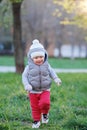 Toddler child in warm vest jacket outdoors. Baby boy at park. Royalty Free Stock Photo