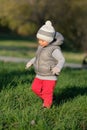 Toddler child in warm vest jacket outdoors. Baby boy at park. Royalty Free Stock Photo