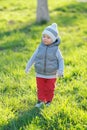 Toddler child in warm vest jacket outdoors. Baby boy at park. Royalty Free Stock Photo