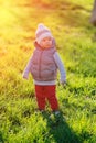 Toddler child in warm vest jacket outdoors. Baby boy at park during sunset. Royalty Free Stock Photo