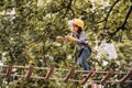 Toddler climbing in a rope playground structure. Children fun. Child concept. Safe Climbing extreme sport with helmet