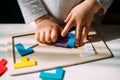 The toddler collects in a colored puzzle on the table Royalty Free Stock Photo