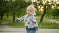 Toddler copying sister movements outdoors. teen girl dancing with little brother