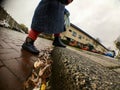 A toddler is crossing the street