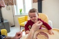 Toddler cute baby girl crying and don& x27;t want to eat food from her father. Royalty Free Stock Photo