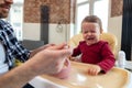 Toddler cute baby girl crying and don& x27;t want to eat food from her father. Royalty Free Stock Photo