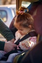 Toddler cute girl buckled into her car seat