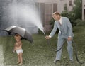 Toddler and dad playing with hose in yard Royalty Free Stock Photo