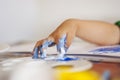 Toddler drawing with colored water color with fingers on a table Royalty Free Stock Photo