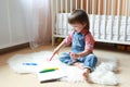 Toddler draws with felt pens at home