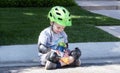 Toddler Dressed in Bicycle Safety Gear Stops for a Snack