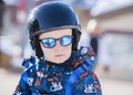 Toddler Dressed Safely for Skiing with Helmet, Harness & Sunglasses