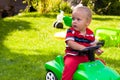 Toddler driving toy car outdoors Royalty Free Stock Photo