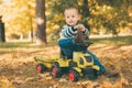 Toddler driving a toy truck in park Royalty Free Stock Photo