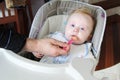 Toddler eating mixed food. Royalty Free Stock Photo