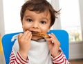 Toddler eating a toast