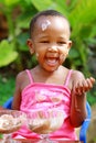 A toddler enjoying ice-cream on a sunny afternoon