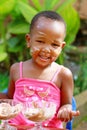 A toddler enjoying ice-cream on a sunny afternoon