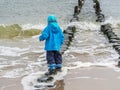 Toddler enjoys the waves baltic sea