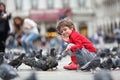 Toddler feeding the pigeons Royalty Free Stock Photo