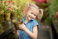 Toddler with flower basket. girl holding pink flowers Royalty Free Stock Photo