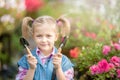 Toddler with flower basket. girl holding pink flowers Royalty Free Stock Photo