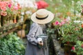 Toddler with flower basket. girl holding pink flowers Royalty Free Stock Photo