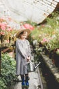 Toddler with flower basket. girl holding pink flowers Royalty Free Stock Photo