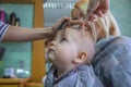 Toddler getting hair cut at hair salon