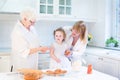Toddler girl baking apple pie with her grandmothers Royalty Free Stock Photo