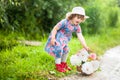 Toddler girl with basket of peony and roses