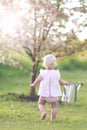 Toddler Girl Carrying Watering Can to Garden Royalty Free Stock Photo