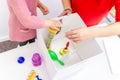 Toddler girl in child occupational therapy session doing sensory playful exercises with her therapist.