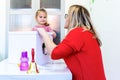 Toddler girl in child occupational therapy session doing sensory playful exercises with her therapist. Royalty Free Stock Photo