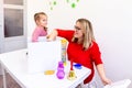 Toddler girl in child occupational therapy session doing sensory playful exercises with her therapist. Royalty Free Stock Photo