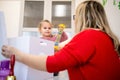 Toddler girl in child occupational therapy session doing sensory playful exercises with her therapist. Royalty Free Stock Photo