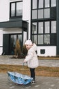 Toddler girl with colorful umbrella outdoors at rainy day Royalty Free Stock Photo