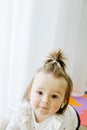 Toddler girl is crawling on floor in room. Concept of childhood, kindergarten and education Royalty Free Stock Photo