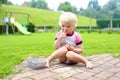 Toddler girl drawing with chalk outdoors Royalty Free Stock Photo