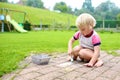 Toddler girl drawing with chalk outdoors Royalty Free Stock Photo