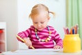 Toddler girl drawing with pencils Royalty Free Stock Photo