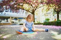 Toddler girl drawing rainbow with colorful chalks Royalty Free Stock Photo