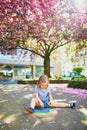 Toddler girl drawing rainbow with colorful chalks Royalty Free Stock Photo