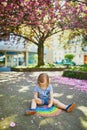 Toddler girl drawing rainbow with colorful chalks Royalty Free Stock Photo