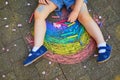 Toddler girl drawing rainbow with colorful chalks Royalty Free Stock Photo