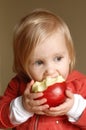 Toddler girl eating apple