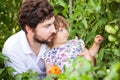 Toddler girl and her father in the greenhouse with tomato plants Royalty Free Stock Photo